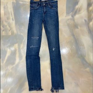 Ripped skinny jeans with raw hem.